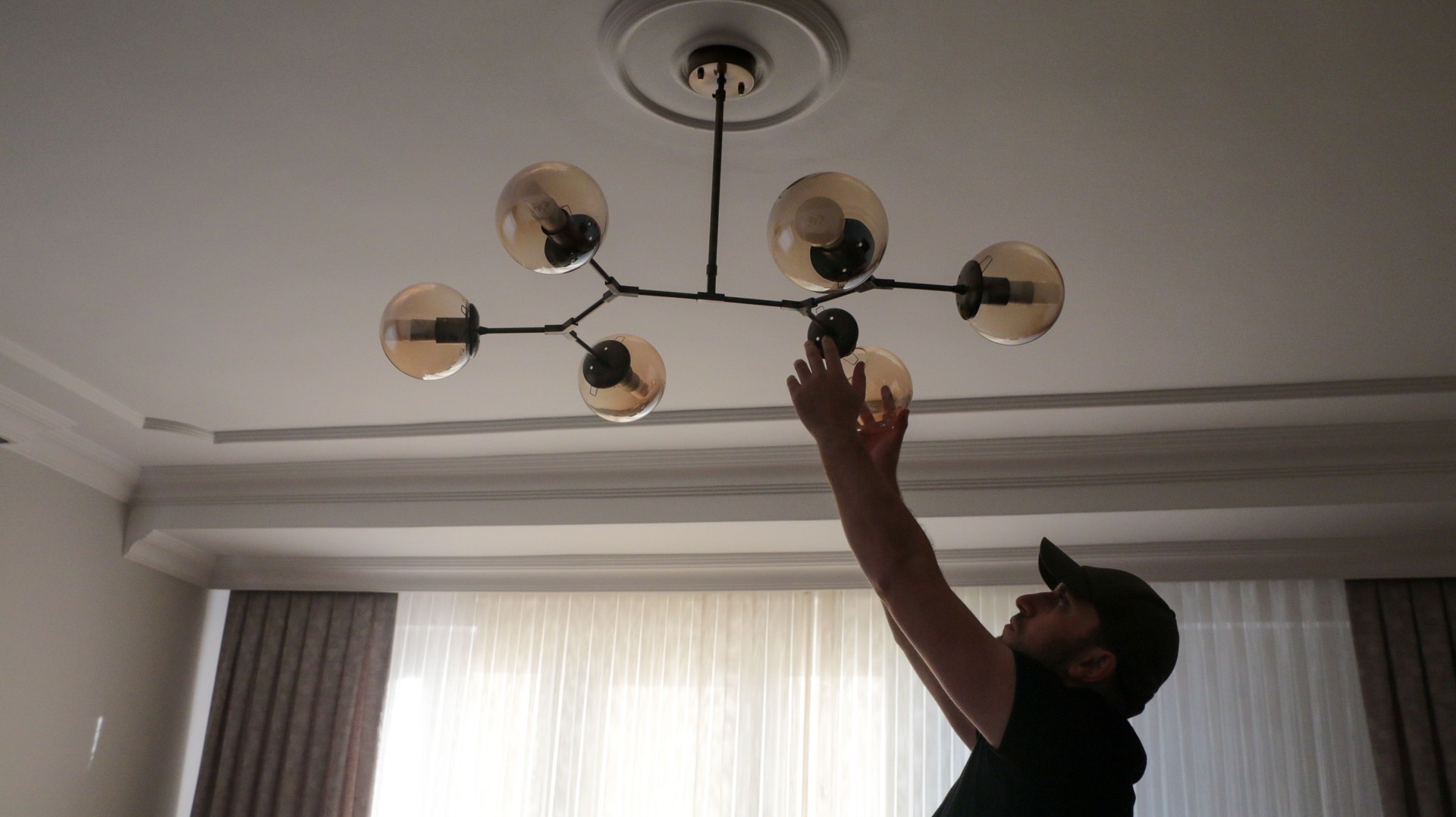 Young man wearing chandelier for decoration